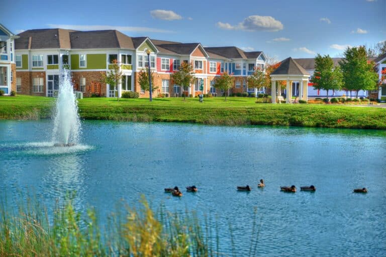Relax by the sparkling pond at our apartments near Austin Landing.